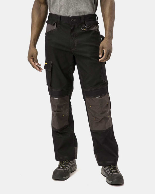 Cat Workwear Men's H2O Defender Work Pants Black on model Front with pockets tucked in, color:Black