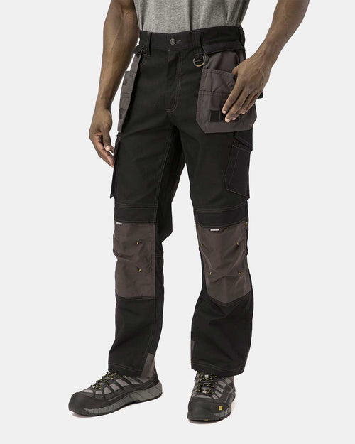 Cat Workwear Men's H2O Defender Work Pants Black on model Front with pockets pulled out, color:Black