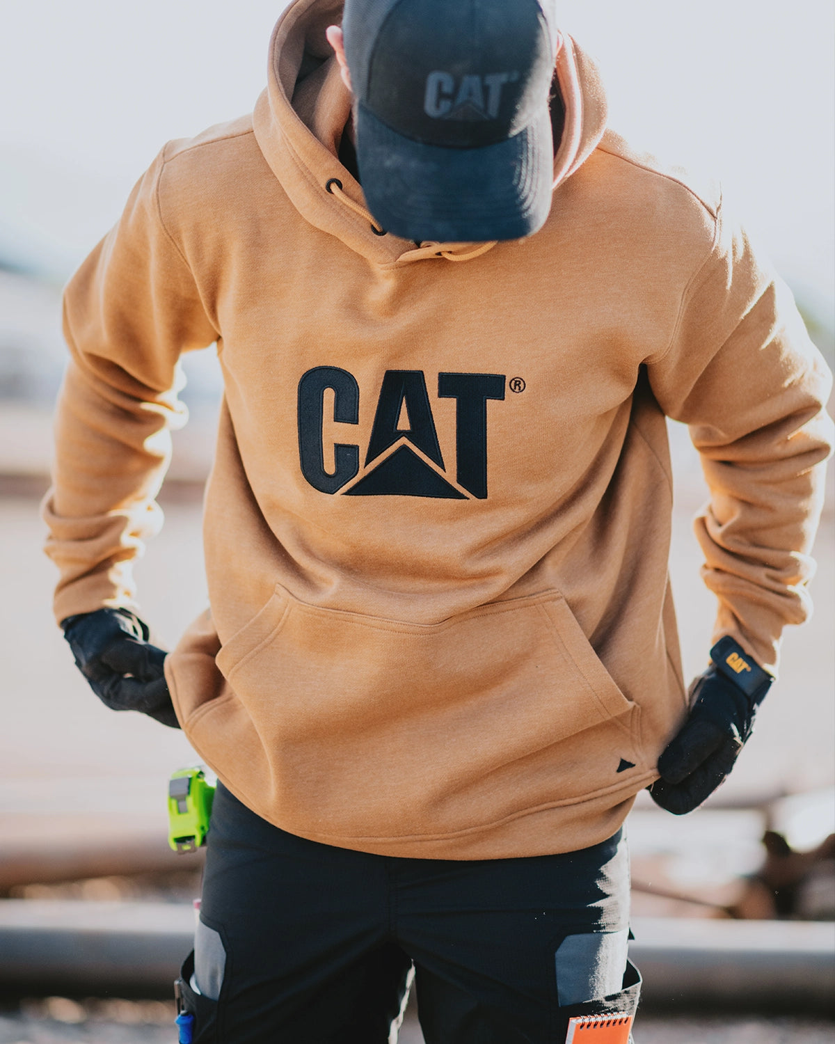 CAT workwear men's heavyweight trademark hoodie bronze on model one