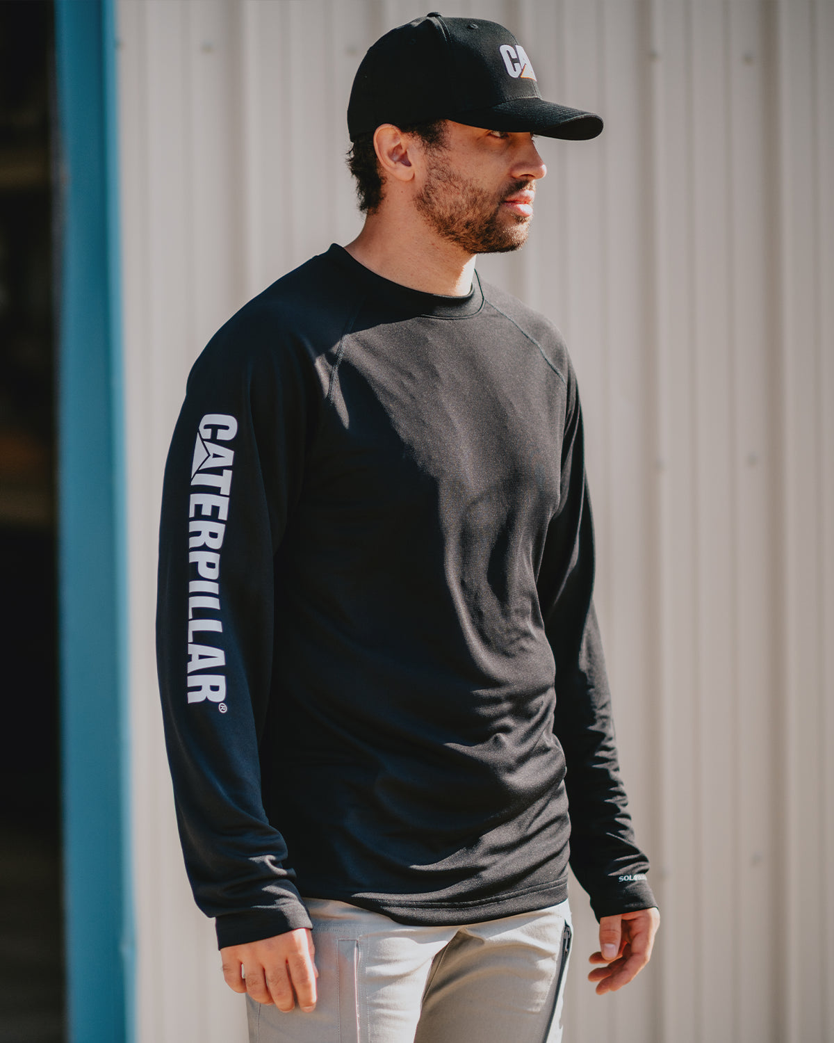 CAT Workwear Men's Lightweight Cooling Long Sleeve Crew Tee Black In Front Of Truck Side