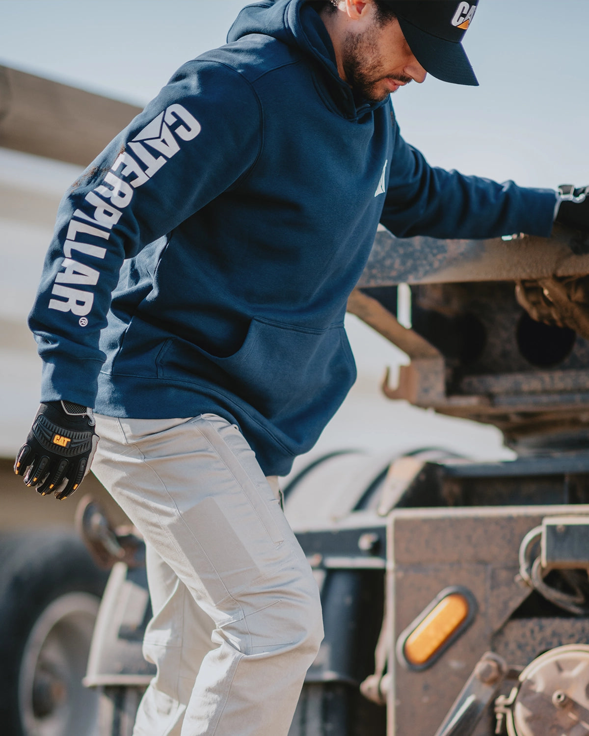 CAT workwear men's midweight trademark banner pullover hoodie detroit blue on model