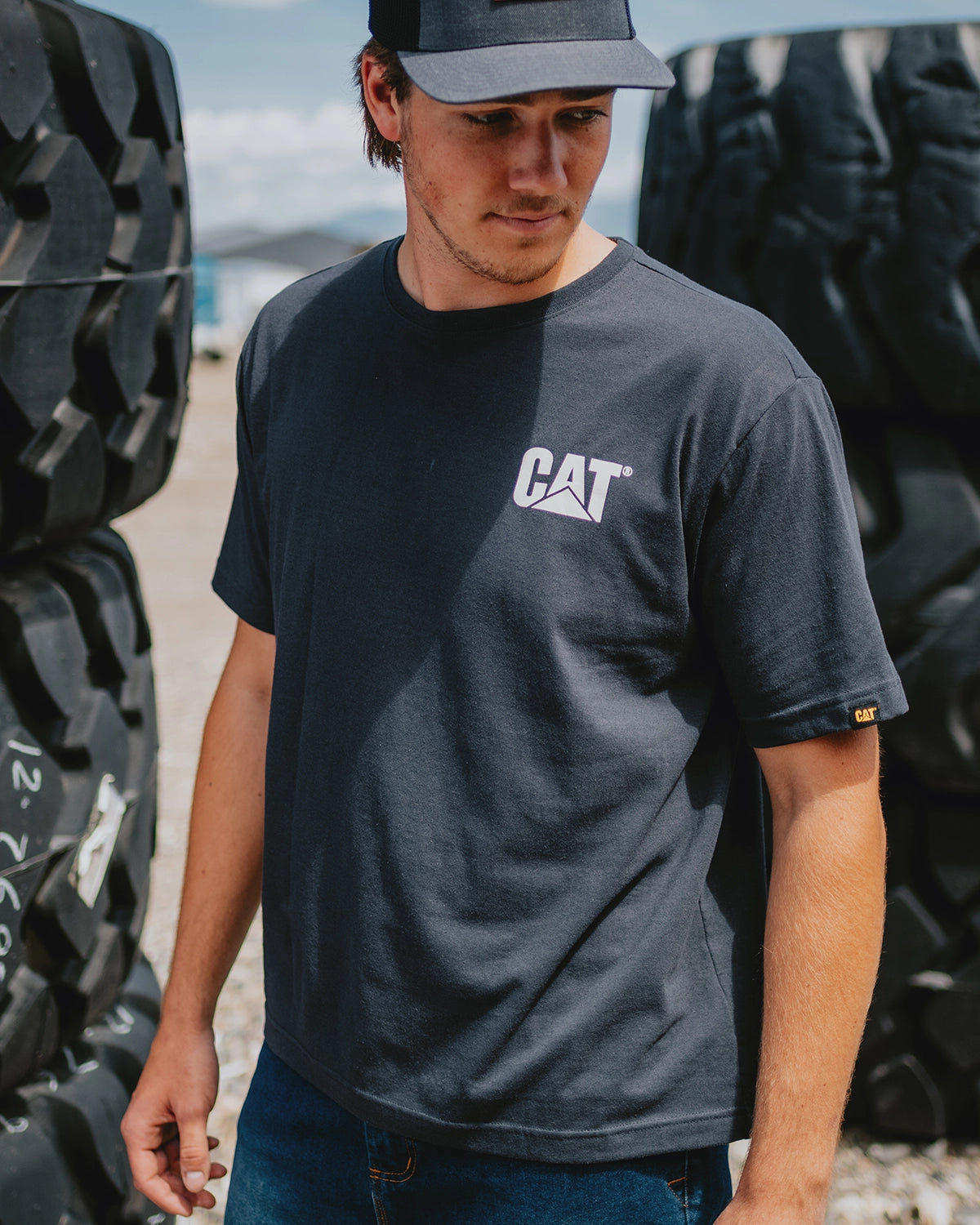 CAT workwear men's thumbs up basic graphic t-shirt washed black vanilla on model front