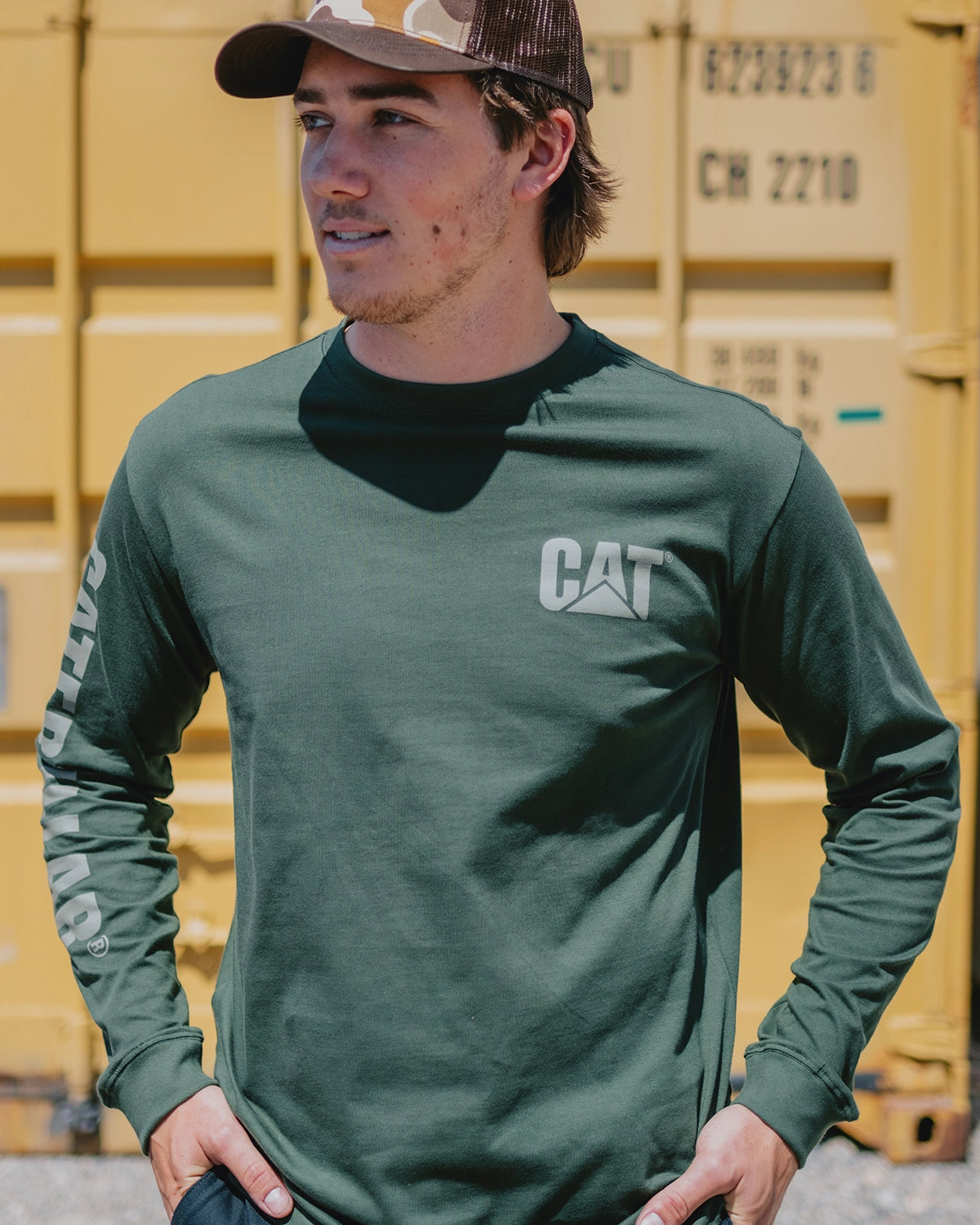 CAT workwear men's trademark banner long sleeve t-shirt forest green on model closeup